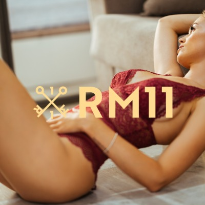 Creator in red lace lingerie posing at home, a beginner selling adult content online in 2026